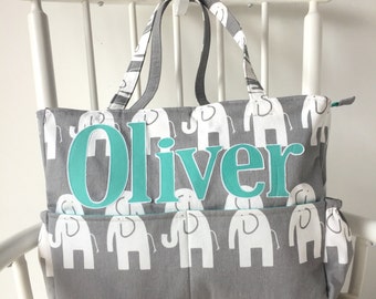 May include: Gray diaper bag with white elephant print and a turquoise name tag that says "Oliver".