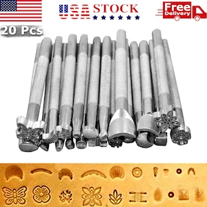 May include: Set of 20 silver leather stamping tools with various designs, including butterflies, flowers, and geometric shapes. The tools are arranged in a row, with the tips facing the viewer. The tools are designed for use with leather crafting projects.