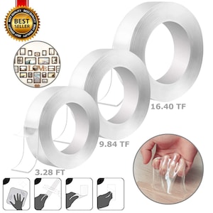 May include: Three rolls of clear, double-sided adhesive tape. The rolls are labeled with the measurements 3.28 FT, 9.84 TF, and 16.40 TF. The tape is shown being used to hang a picture frame and a mirror.