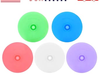 May include: A set of five circular silicone lids in green, blue, red, white, and purple. Each lid features a central circular vent and the embossed text THIS SIDE UP. The lids are arranged in a pattern with two on top and three on the bottom.