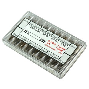 May include: A clear plastic case containing a set of 20 stainless steel spring bar watch bands. The bands are organized by size, ranging from 8mm to 25mm. The case has a label that reads "Double Flange Spring Bar, Dia: 1.50mm, @20pcs Total: Pcs".