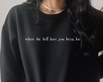 Puede incluir: Sudadera negra con el texto "where the hell have you been, joe" impreso en blanco.