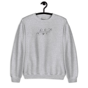 May include: A heather grey sweatshirt with a floral design and the text "inhales deeply!" printed on the front.