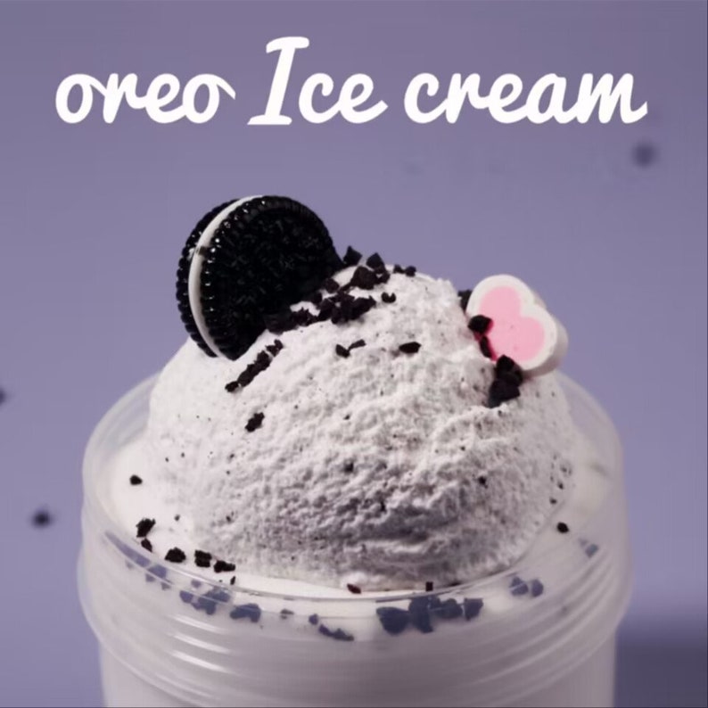 May include: A close-up of a dessert item labeled "oreo Ice cream". The dessert features a scoop of white ice cream with dark chocolate cookie crumbles and a half Oreo cookie on top. A pink and white heart-shaped decoration is also visible.