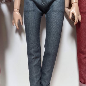 May include: A pair of dark blue denim jeans with cuffed hems.