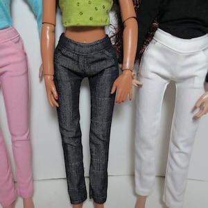 May include: Three pairs of pants in different colors: pink, blue denim, and white. The pants are all slim-fitting and have a similar style.
