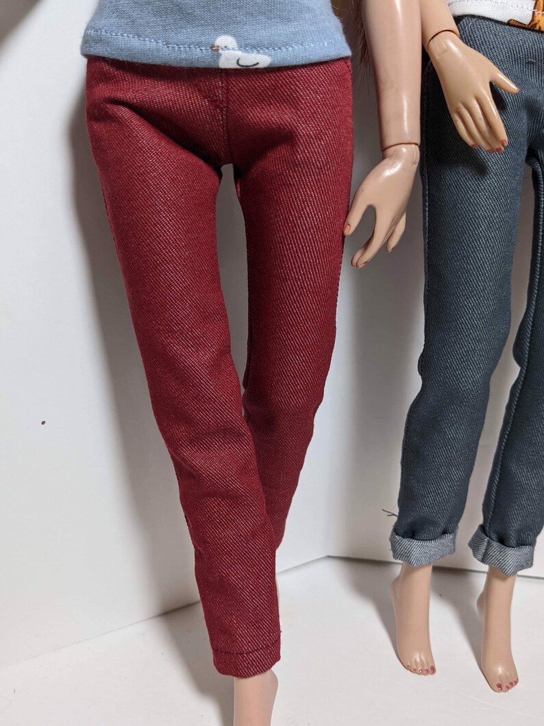 May include: A pair of red denim pants with a straight leg fit. The pants are made of a soft, comfortable fabric and have a classic look.