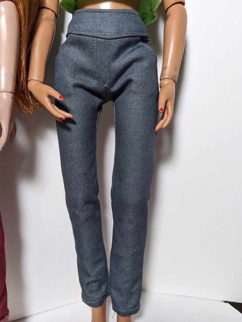 May include: A pair of dark gray denim pants with a high waist and a slim fit.