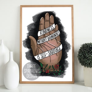 May include: A framed art print featuring a hand illustration with the text "Kindness Without Boundaries Is Self-Sabotage." The artwork has a brown hand with a black and gray background, and the words are on a white banner. The print also includes the text "Three Sparrows Design."