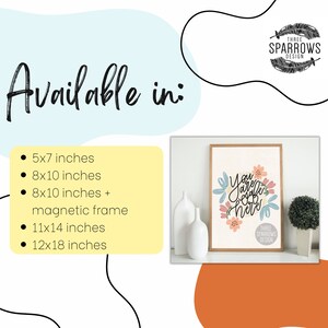 May include: A framed art print with the text "You are safe here" surrounded by floral illustrations in pink, blue, and peach. The image is available in various sizes, including 5x7, 8x10, 11x14, and 12x18 inches, with an option for a magnetic frame.
