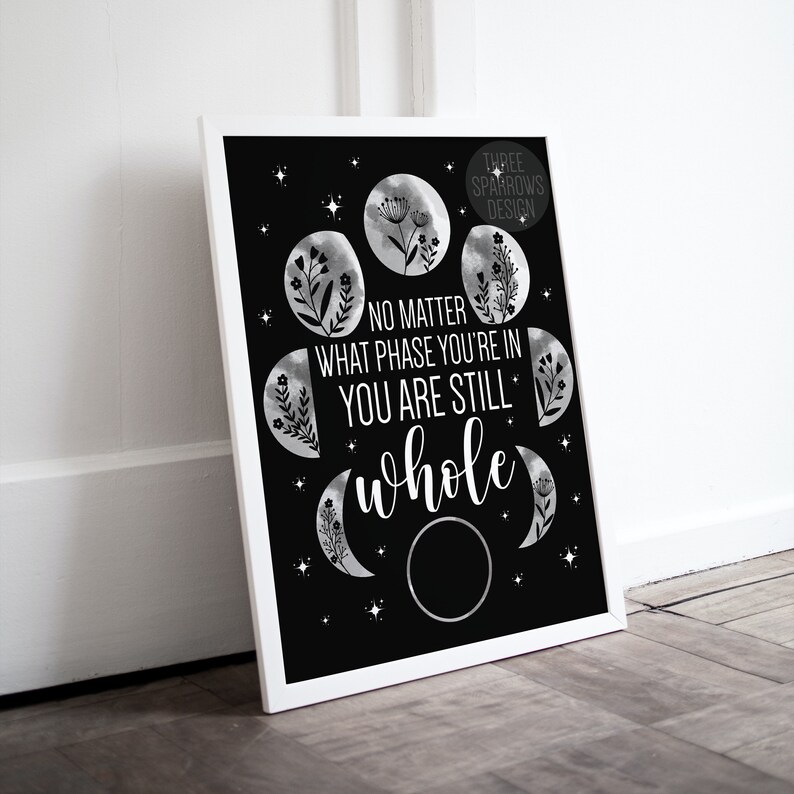 May include: Black and white printable art print with a quote that reads "No matter what phase you're in you are still whole". The quote is surrounded by a circle of moon phases with floral accents.