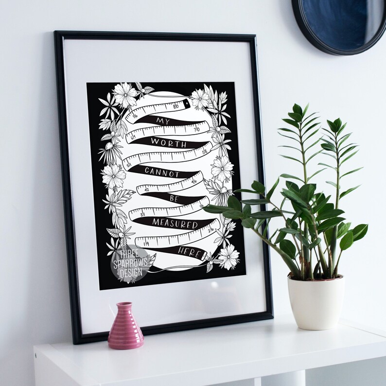 May include: Black and white printable art print with a quote that reads "My worth cannot be measured here." The quote is surrounded by a series of curved measuring tapes and floral illustrations.