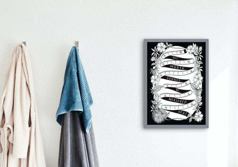 May include: Black and white printable art print with a quote about self-worth. The quote reads "My worth cannot be measured here." The quote is surrounded by a decorative border of flowers and a measuring tape.