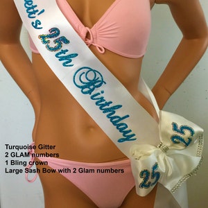 May include: White satin sash with turquoise glitter lettering that reads "Svett's 25th Birthday". The sash has a large white bow with two turquoise glitter numbers "25" on it.