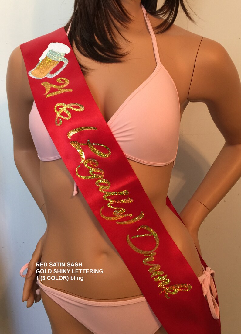 May include: Red satin sash with gold shiny lettering that reads "21 & Legally Drunk" with a beer mug graphic.