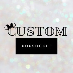 May include: A black and white graphic design with the word "CUSTOM" and the text "POPSOCKET" below it. The graphic design features a stylized Mickey Mouse head with a bow.