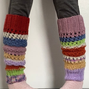 May include: Multicolored knitted leg warmers with a variety of textures and patterns, including stripes, lace, and cable knit.