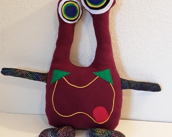 Monstruo espacial de peluche burdeos