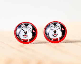 May include: A pair of red stud earrings with a white and black husky dog image on each earring. The husky has a red bow tie and a red heart above its head.