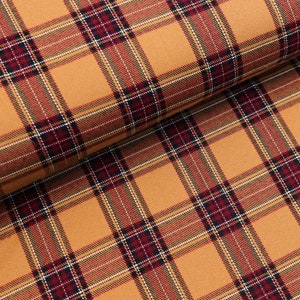 Pode incluir: Tecido xadrez laranja, vermelho e preto com textura tecida.