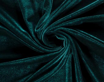 May include: A deep emerald green velvet fabric featuring a dense, soft pile with a subtle sheen. The material is gathered into a central swirl, creating natural folds and shadows that highlight the rich, saturated color and texture of the textile.