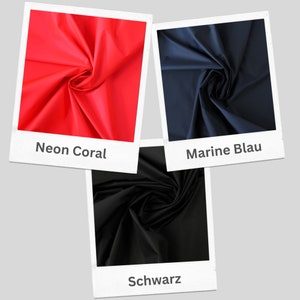 May include: Three fabric swatches in different colors: neon coral, marine blue, and black. Each swatch is folded and displayed in a white frame with the color name written below.