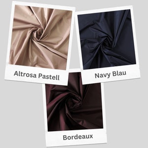 May include: Three fabric swatches in different colors: a light beige, a dark blue, and a deep burgundy. The fabric is a smooth, shiny material.
