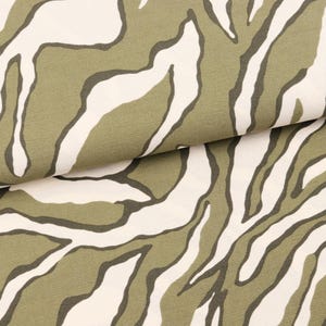 Pode incluir: Tecido verde e branco com padrão de listras de zebra.