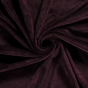 May include: Close-up of a deep burgundy velvet fabric, showcasing its soft texture and rich colour.