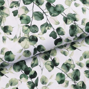 May include: White fabric with a repeating pattern of green eucalyptus leaves and branches. The leaves vary in shades of green, with some showing lighter, almost white, accents. The design is a watercolor style, creating a soft, natural aesthetic.