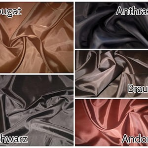 Pu&ograve; includere: Primo piano di cinque campioni di tessuto in diversi colori: Nougat, Antracite, Marrone, Nero e Andorra. Il tessuto &egrave; un raso liscio e lucido.