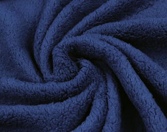 May include: A deep navy blue fabric with a thick, plush, and fuzzy texture. The material is arranged in a swirling, gathered pattern that highlights the dense, soft pile and the consistent dark blue color throughout the entire surface area.