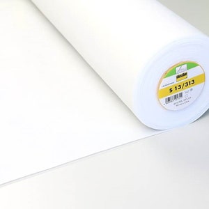 May include: A white roll of fusible interfacing fabric with a label that reads "S 13/313 65% PES 35% CV 90 cm x 25 m."