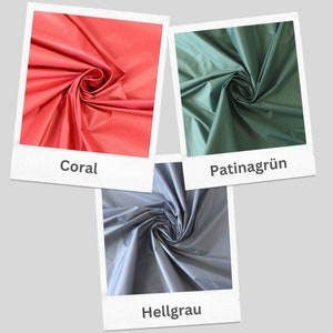 May include: Three fabric swatches in different colors: coral, patina green, and light gray. Each swatch is folded in a spiral shape.