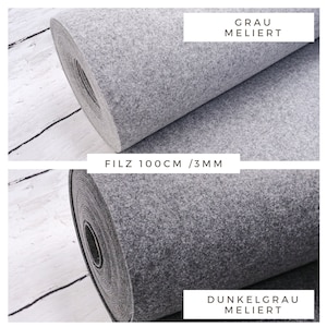 May include: Two rolls of felt fabric, one grey and one dark grey, both with a mottled texture. The fabric is 100 cm wide and 3 mm thick. The text "FILZ 100CM / 3MM" is printed on a white label.
