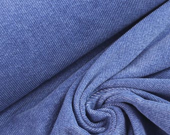May include: A bolt of blue corduroy fabric featuring a distinct vertical ribbed texture. The material is draped in soft folds, showcasing the consistent parallel lines and the deep, solid blue color throughout the entire surface of the textile.