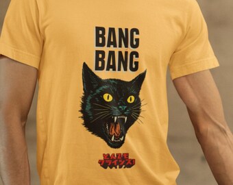 May include: Mustard yellow t-shirt with a black cat graphic, yellow eyes, and an open mouth. The text "BANG BANG" is above the cat, and Japanese text is below the cat.