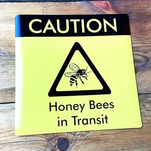 Square Bees in Transit Sign, made of magnetic material with outdoor use vinyl finish, this long lasting sign is ideal for repeated use on vans, cars and other forms of transport to warn of your precious cargo. This can be used in the same way as an L Plate and can be clipped onto any magnetic surface and also safely removed and used repeatedly.