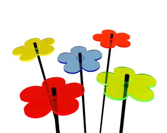 Könnte beinhalten: Fünf bunte, blumenförmige Dekorationen aus Acryl auf schwarzen Metallstielen. Die Blumen sind rot, gelb, blau und grün.