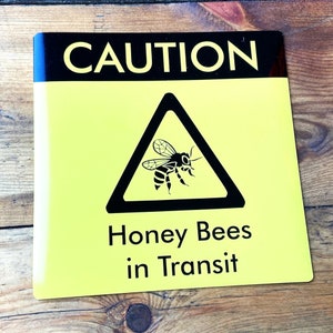 Square Bees in Transit Sign, made of magnetic material with outdoor use vinyl finish, this long lasting sign is ideal for repeated use on vans, cars and other forms of transport to warn of your precious cargo. This can be used in the same way as an L Plate and can be clipped onto any magnetic surface and also safely removed and used repeatedly.