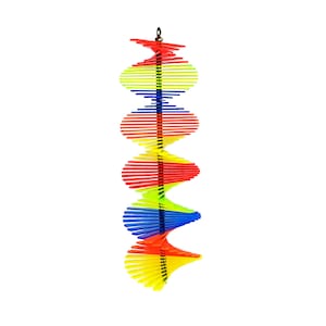 May include: A colorful, multi-layered, spiral wind spinner with yellow, red, blue, and green sections. The spinner is made of wood and is suspended from a metal hook.