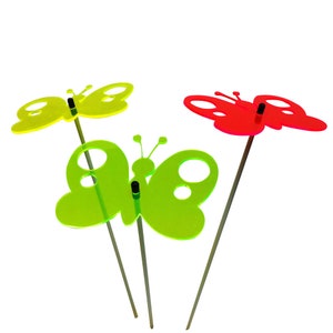 May include: Three colorful butterfly garden stakes, one red, one green, and one yellow. The stakes are made of acrylic and have a simple design.