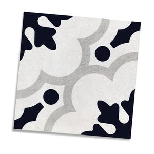 May include: Square decorative tile with a repeating pattern. The design features a combination of white, light grey, and navy blue shapes, including floral-like forms and circular accents. The tile has a textured appearance.
