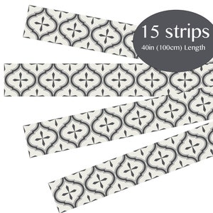 May include: Fifteen decorative strips with a repeating gray and white quatrefoil pattern. Each strip is 40 inches (100cm) long. The strips are arranged at different angles against a white background.