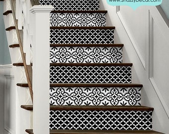 May include: Staircase with decorative black and white patterned stair risers. The risers feature a repeating geometric design. The text "Stair Riser Peel & Stick" is visible in the upper right corner.