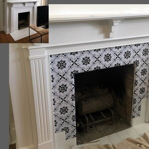May include: A white fireplace with a black and grey patterned tile surround. The fireplace opening is dark, with a metal grate and a log inside. The mantel is white.