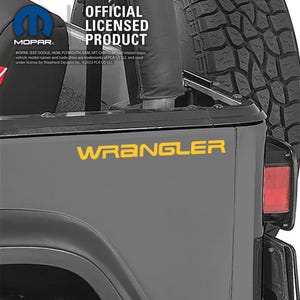 May include: A section of a gray Jeep Wrangler with the word "WRANGLER" in yellow lettering. The image also includes the MOPAR logo and the text "OFFICIAL LICENSED PRODUCT".