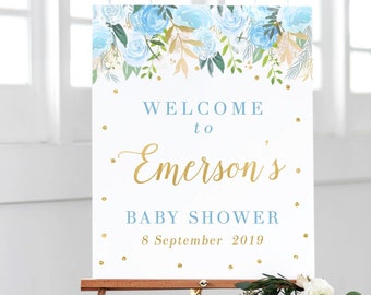 May include: Welcome to Emerson's Baby Shower sign with blue and gold floral design and gold glitter. The sign says "Welcome to Emerson's Baby Shower 8 September 2019".