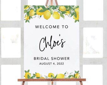 Peut inclure: Une pancarte d'accueil blanche avec une bordure de citrons et de fleurs. La pancarte indique "Bienvenue à Chloe's Bridal Shower le 4 août 2022".