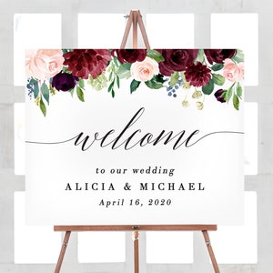 May include: A wedding welcome sign featuring a floral design in shades of burgundy, pink, and green. The sign reads "Welcome to our wedding Alicia & Michael April 16, 2020".